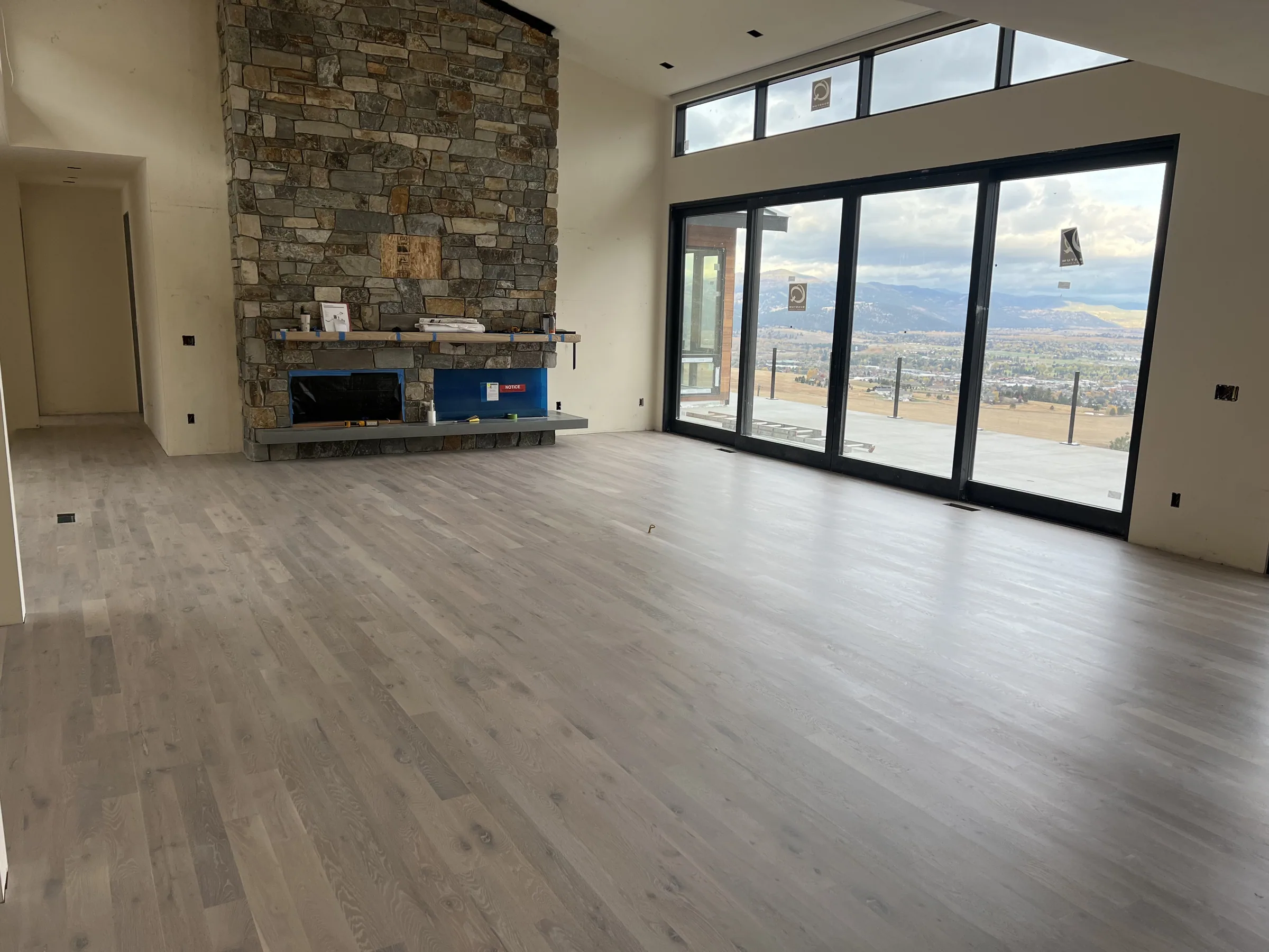 Hardwood floor in a Missoula home with mountain views through the windows